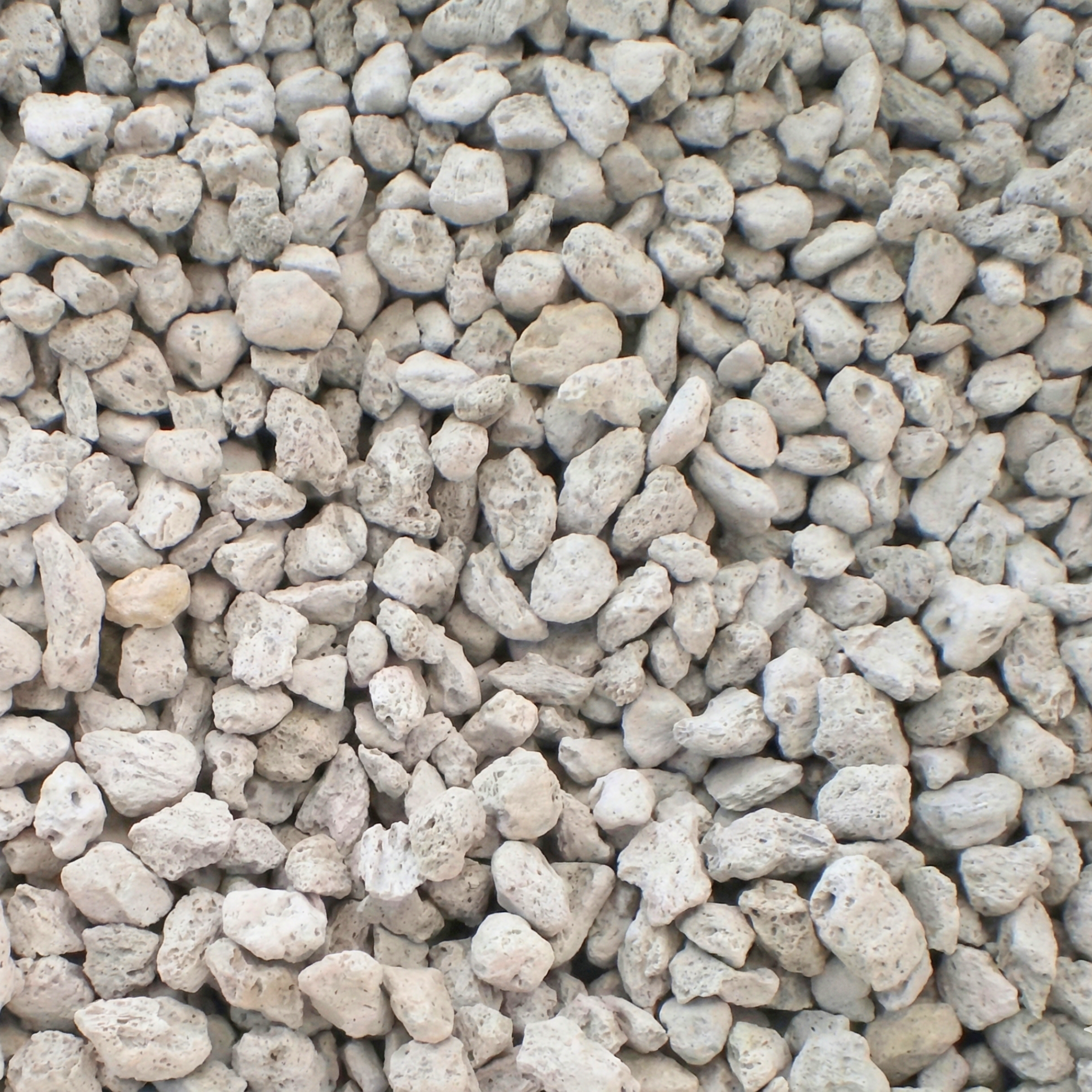 Fine pumice in pots, lightweight volcanic substrate to improve drainage and aeration for plants.