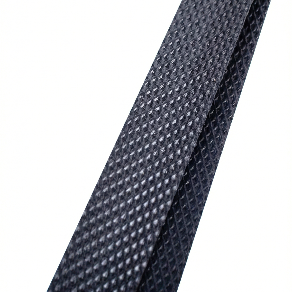 Detail of the texture and resistance of a black polypropylene PP strap for industrial packaging in Punta Cana.