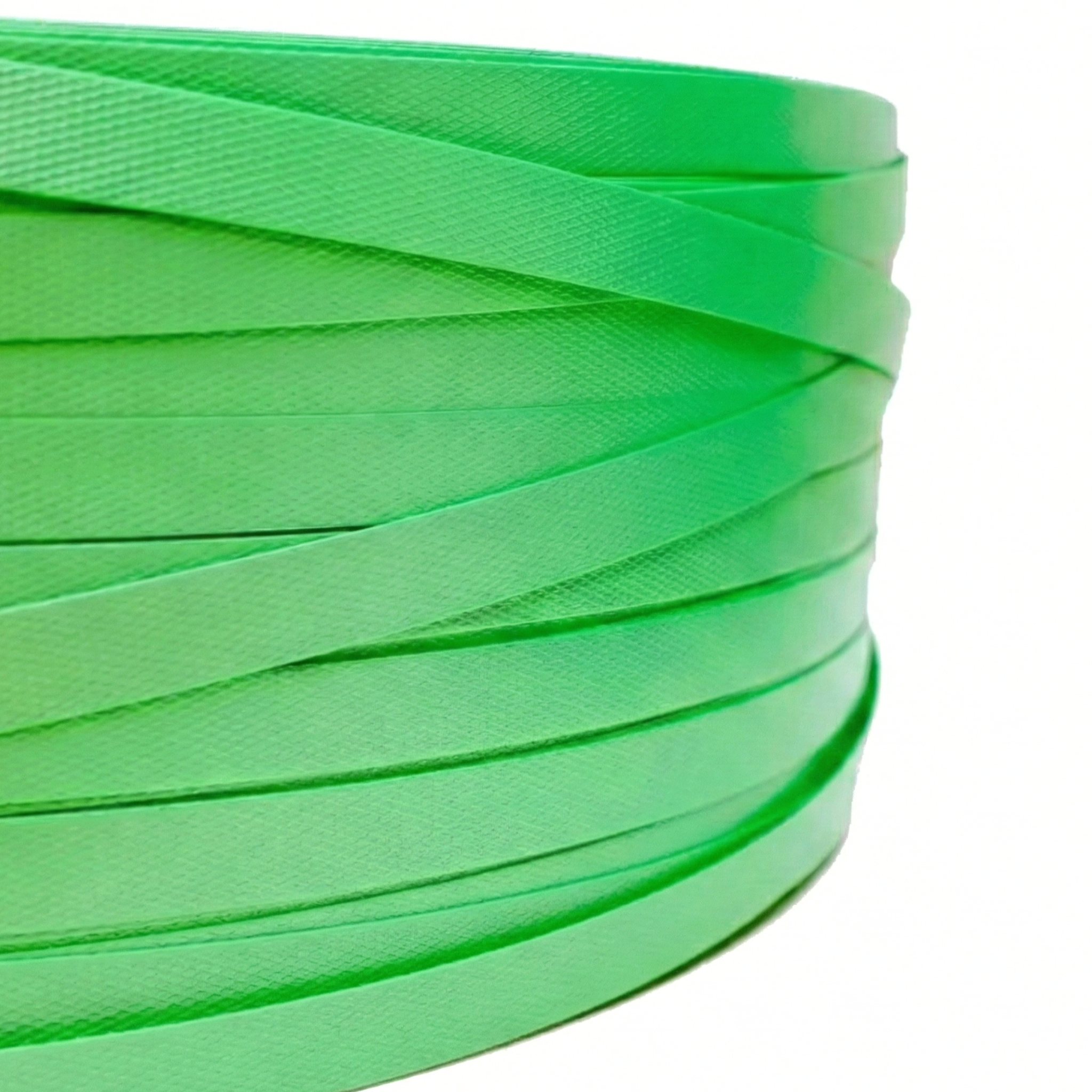 Complete roll of green PET strap or strapping, rigid industrial material used for palletizing merchandise and blocks.